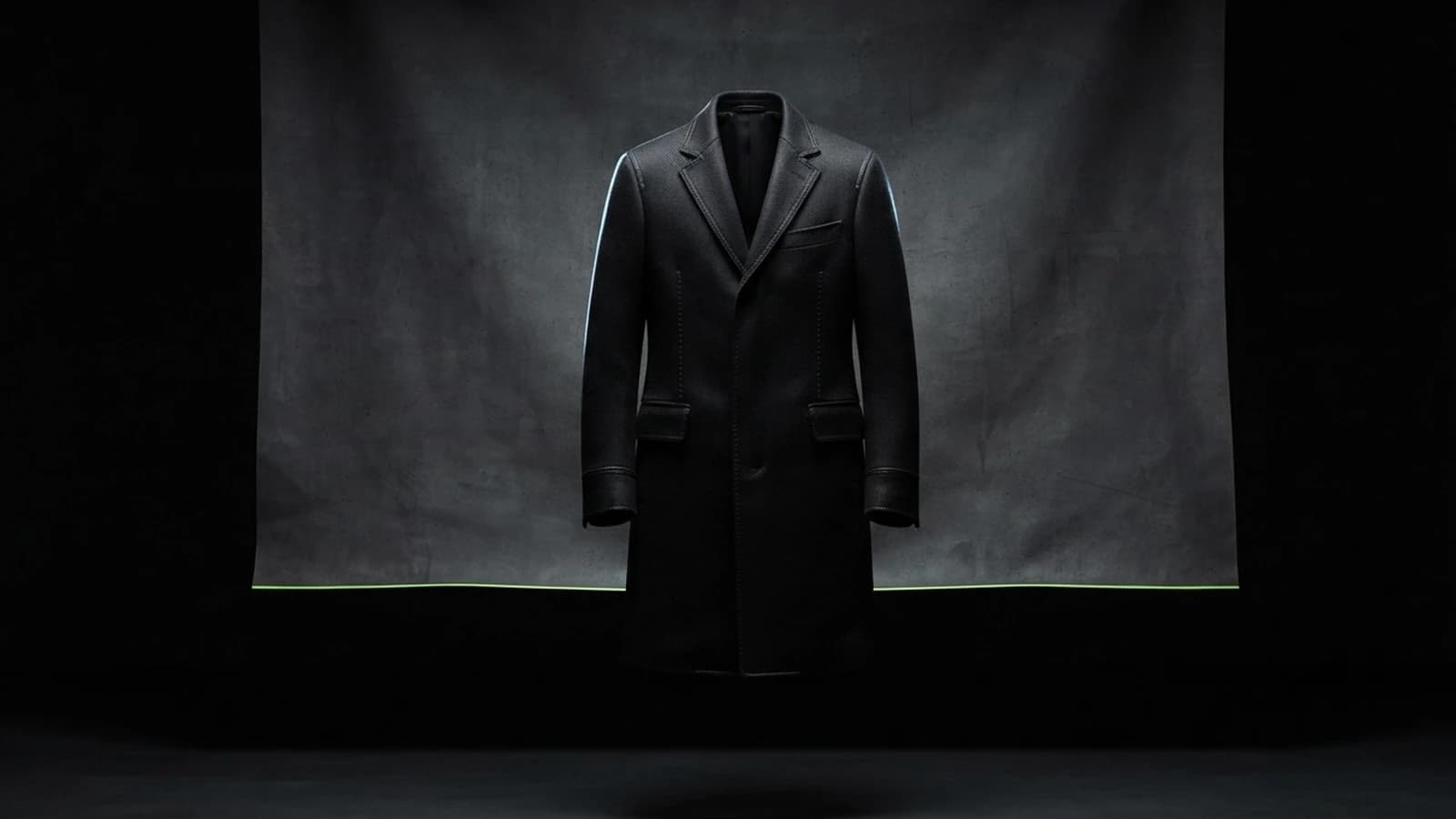 Black-on-black coat photographed with rim light to show texture